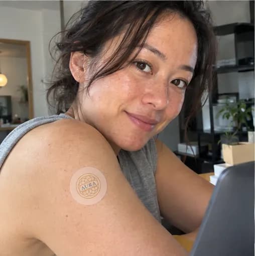 Person wearing an Aura patch while at a desk